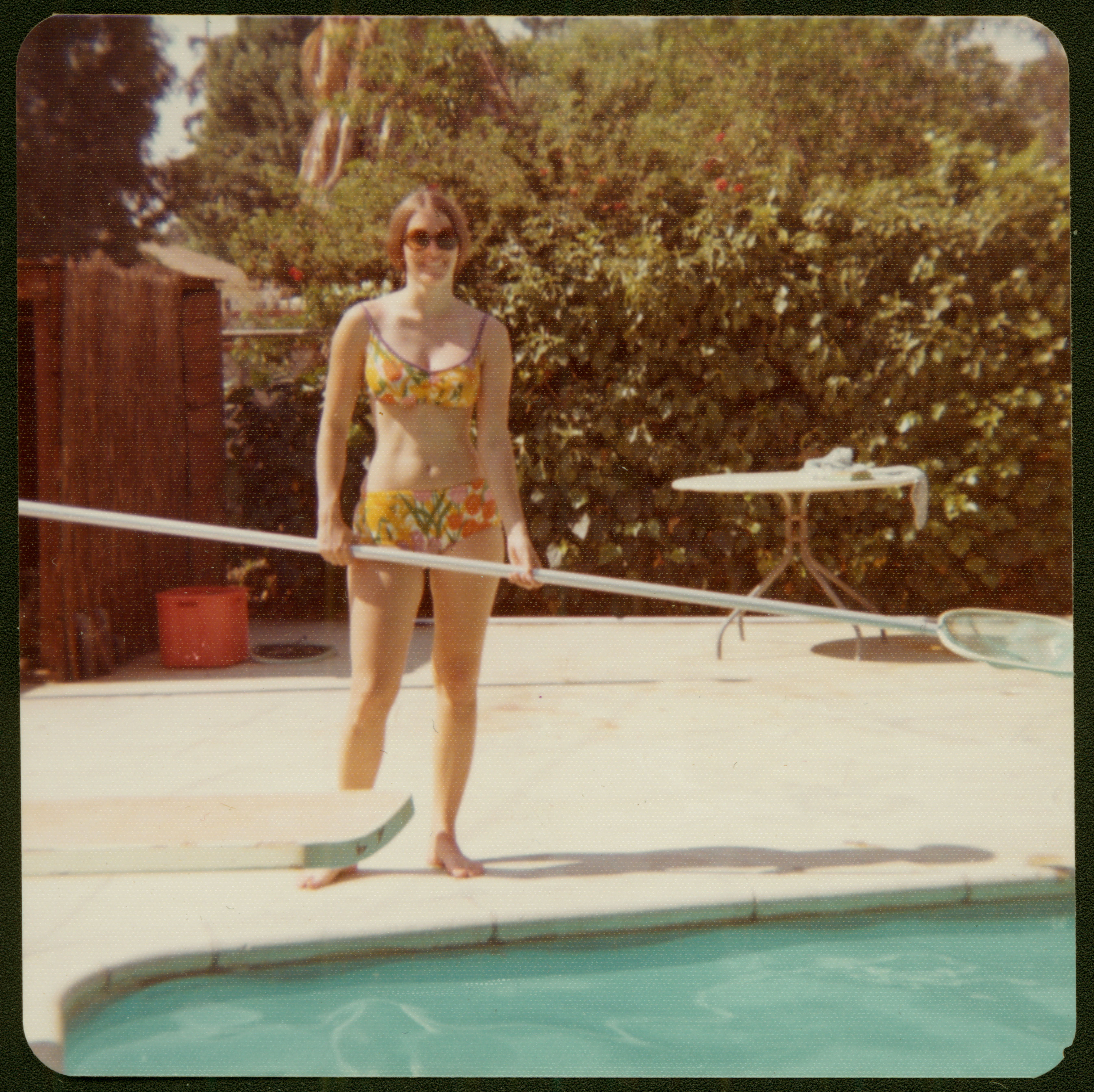 Signe Snortland cleans the family inground pool in the 1970s. Her groovy bikini is part of the museum collections. SHSND 2007.13.53