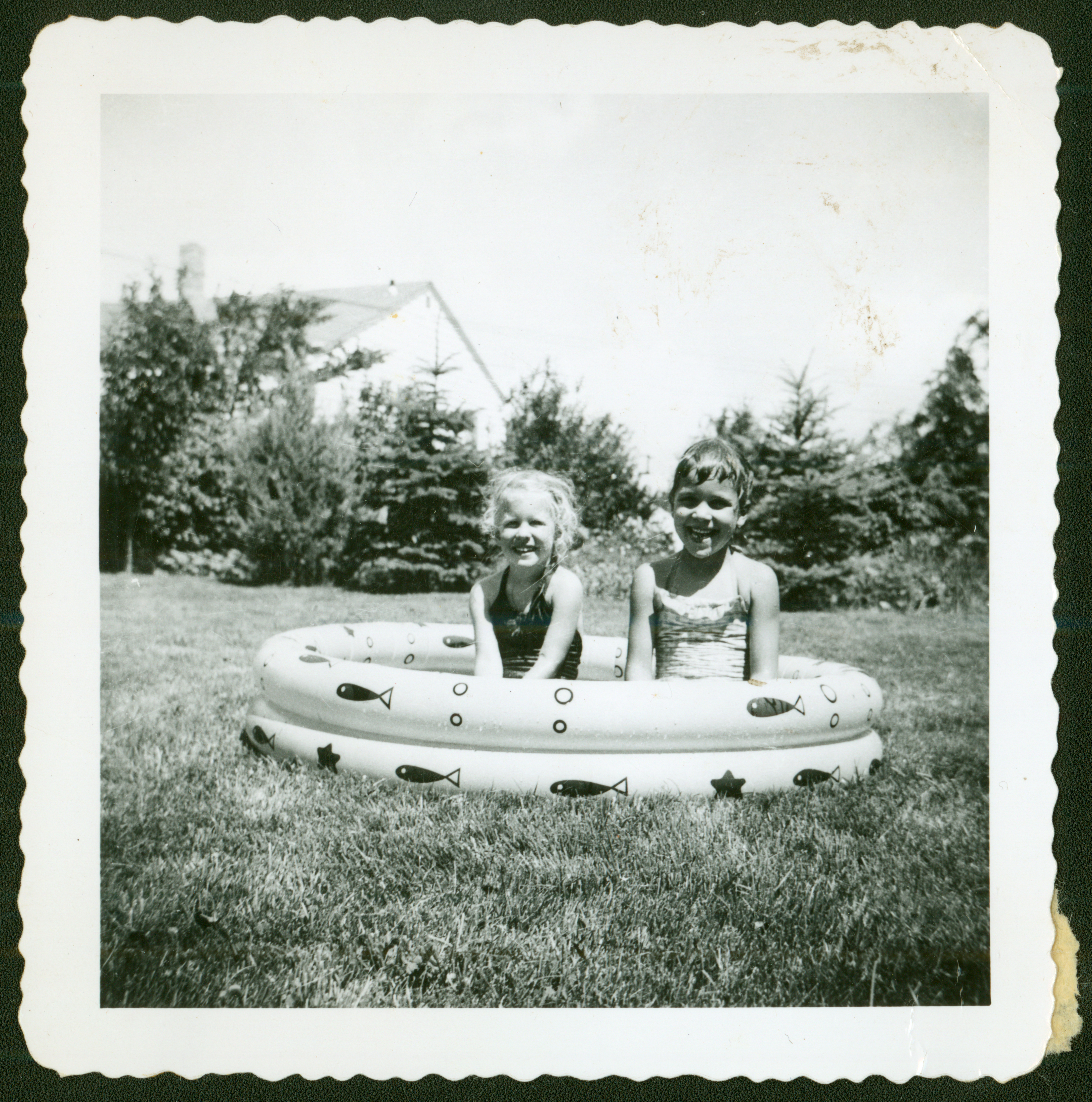 Signe and Kristi Snortland sit in an inflatable kiddie pool in the 1950s. SHSND 2007.13.26