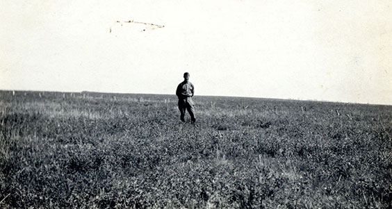 Photo of Howard R. Huston standing in field