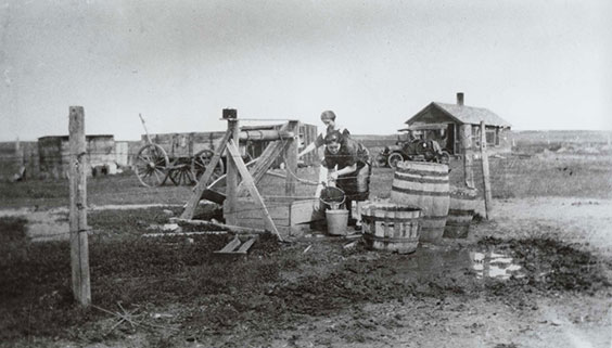 Two women draw water from a well