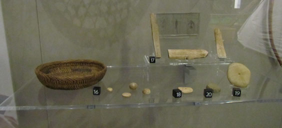 Ice glider bone, game basket, and gaming pieces on exhibit