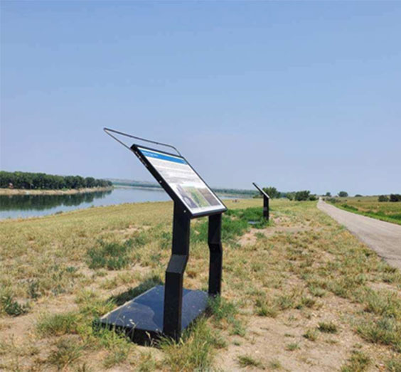 An outdoor sign installed with the attached piece of metal at the top to keep birds from pooping on the sign