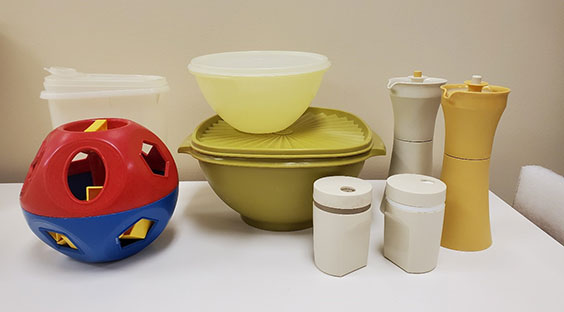 An array of tupperware products, including a set of salt and pepper shakers, bowls, a toy, and more.