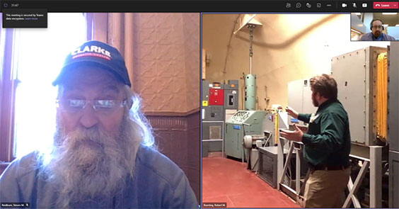 An older gentleman with glasses, long white gray hair and beard, black hat, and denim shirt is shown on the left side of the screenshot while a younger man in khaki pants, green button up shirt, with red hair a beard stands showing the underground capsule at a missile site..