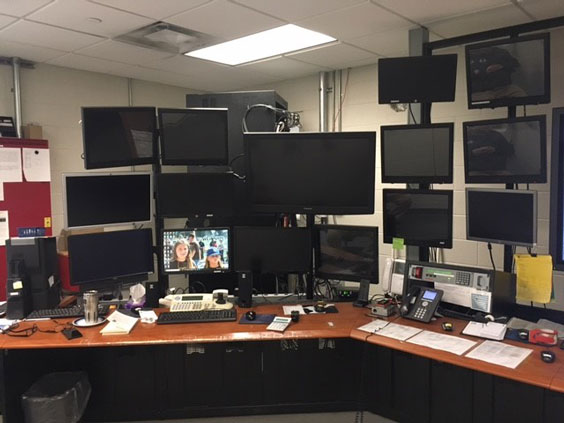 A room is shown with many monitors stacked high on stands.