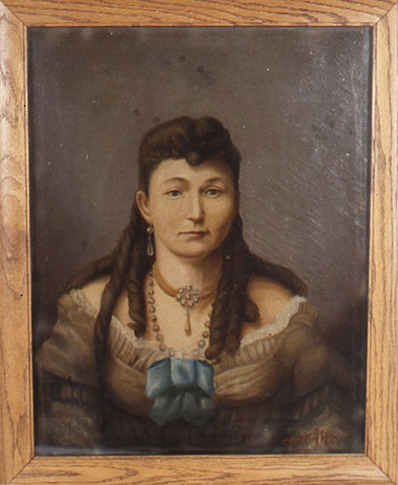 A painted portrait of a woman with long, dark curls in her hair, an orange choker necklace with pearls forming a circle in the middle, a longer pearl nexklace, and an off the hsoulder dress or blouse with lacy fringe and a blue bow in the middle at chest level. The painting is framed in a light colored wood.