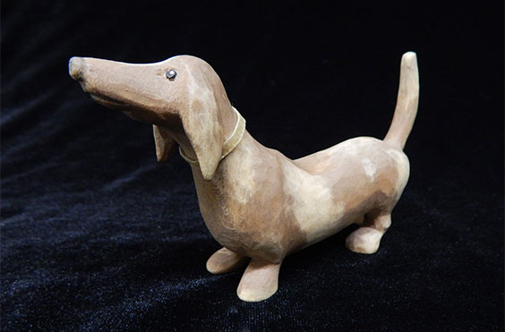A wood carved figure of a Dachshund