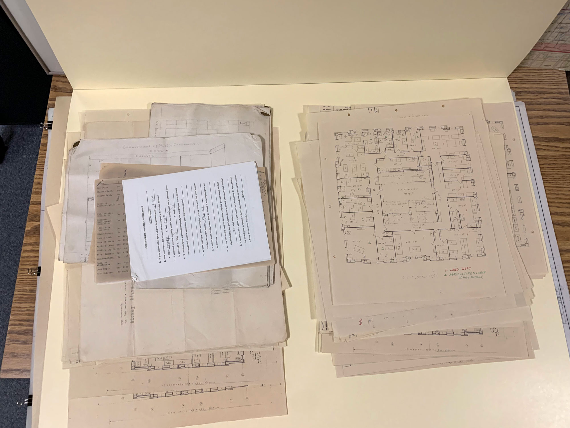 a yellowish folder with two stacks of paper in it