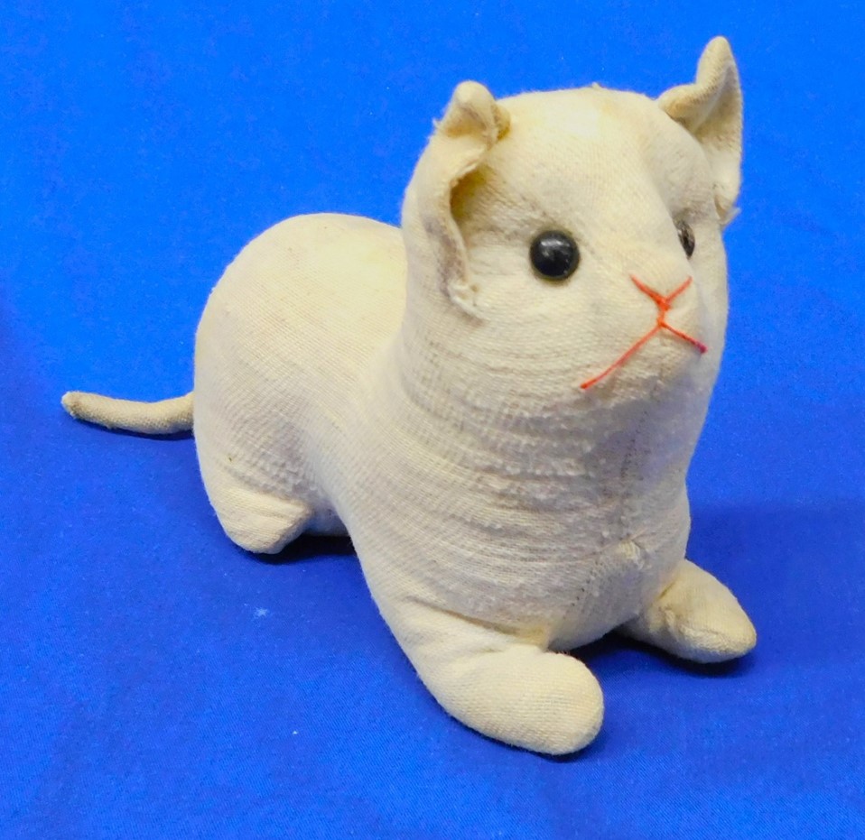 Cream colored stuffed toy cat