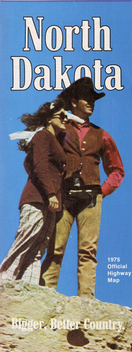 Map cover that says North Dakota - Bigger, Better Country. 1975 Official Highway Map. The image on the map shows a man and woman dressed in western gear standing on a large rock or butte with blue behind them.