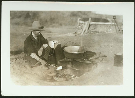 Cowboy cooking outdoors