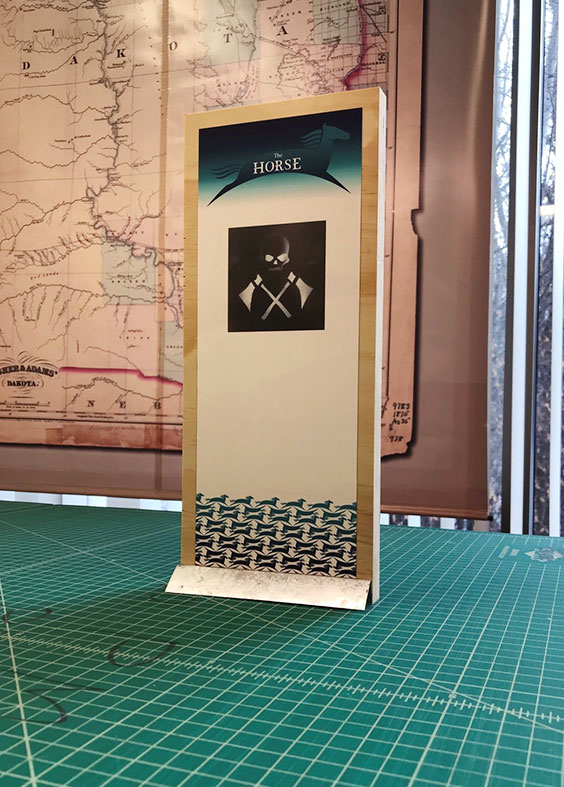 small scale display mockup featuring a sticker graphic on front