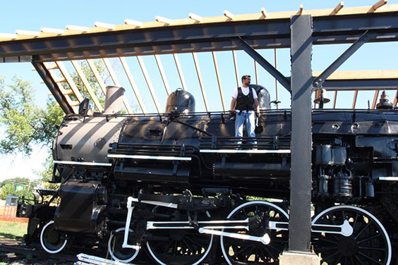 Bryan standing on top of a train