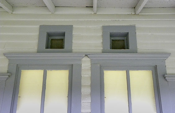 two small square windows above a larger window