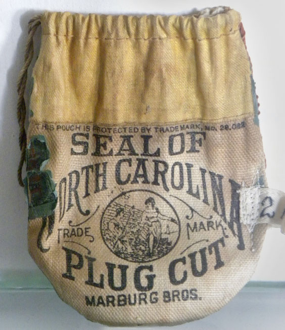tan drawstring bag with black letters on front used for tobacco