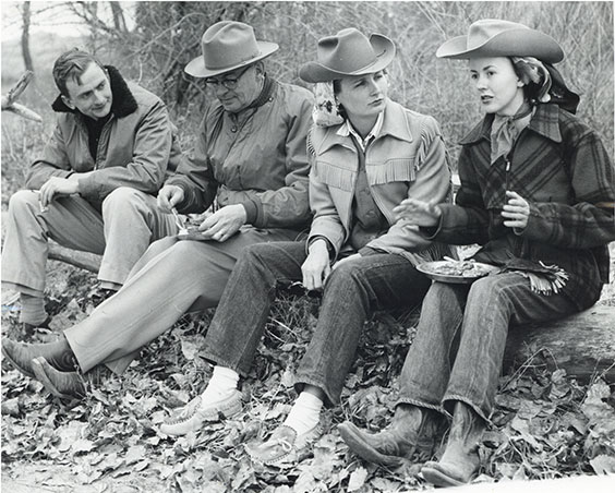 BW vintage photo of 4 people dressed in western clothing at a rodeo