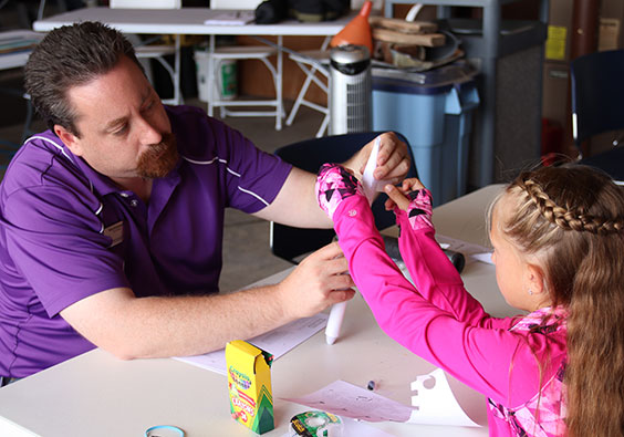 Chris Dorfschmidt showing girl rocket craft project