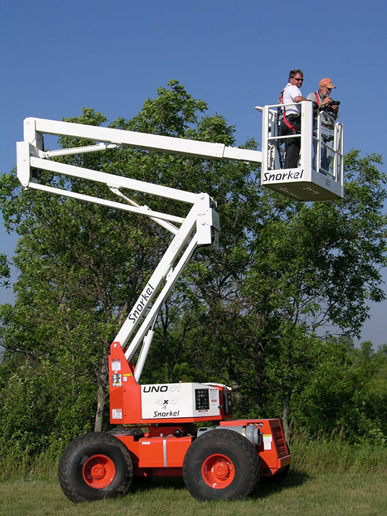 two men working in a crane bucket