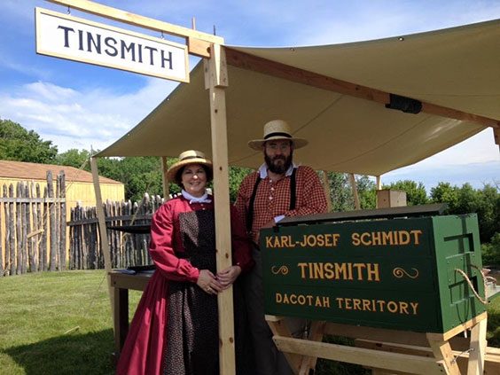 Karl and Nadine Schmidt in front of their Tinsmithing stand at Fort Abercrombie