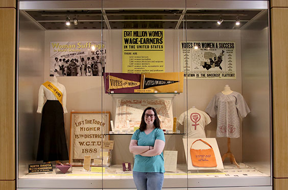 Elise Dukart, guest blogger standing in front of exhibit case