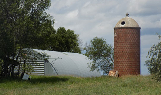 A.C.O. silo by a quonset hut