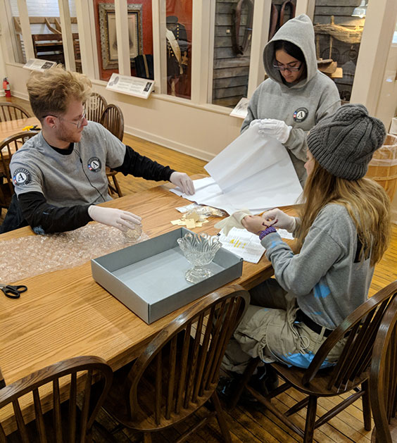 AmeriCorps team members rehousing collections