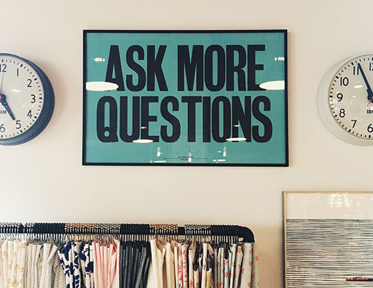 Ask More Questions sign