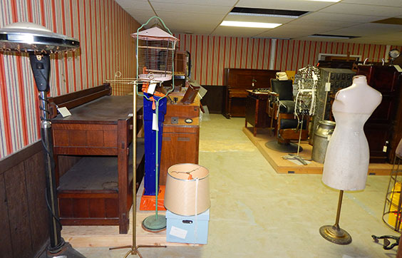 room with striped walpaper and many artifacts