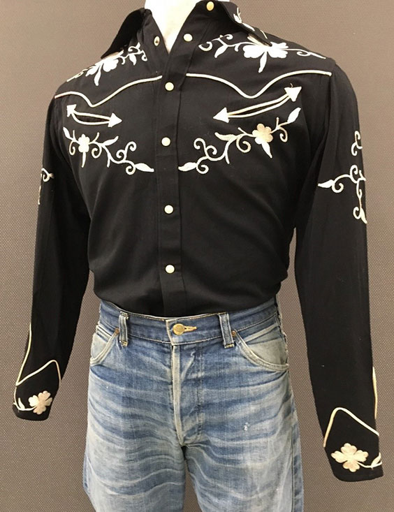 Black button up shirt with white snaps and white embroidered floral designs on the chest, shoulders, cuffs, and upper arms