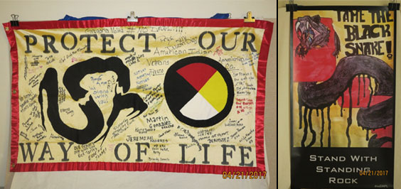 Flags reading Protect Our Way of Life and Tame the Black Snake! Stand With Standing Rock