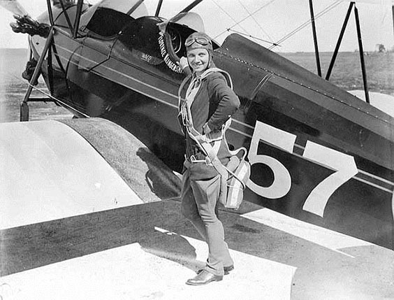 Florence Klingensmith standing in front of an airplane with the number 57 on it