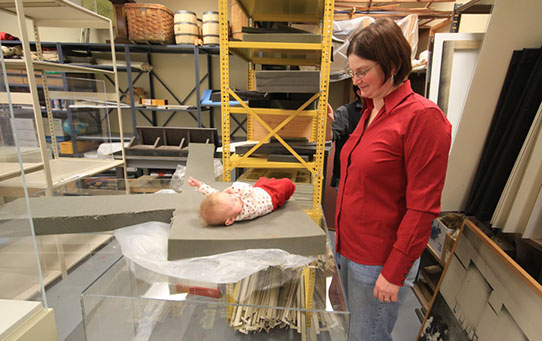 Employee watching her baby daughter on a foam piece