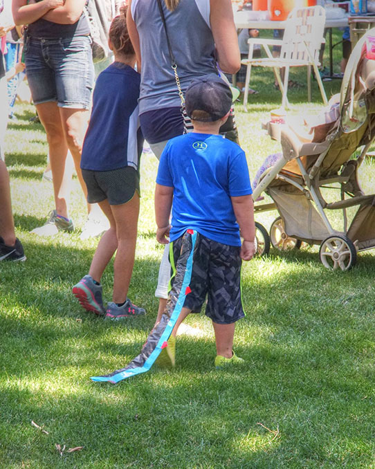 Child with dinosaur tail