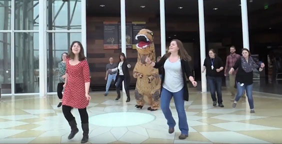 Group dancing, including a t. rex