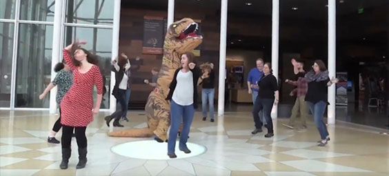 Group dancing, including a t. rex