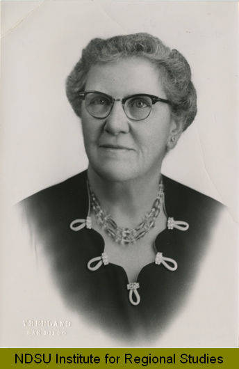 Portrait of Minnie Craig wearing glasses and a necklace