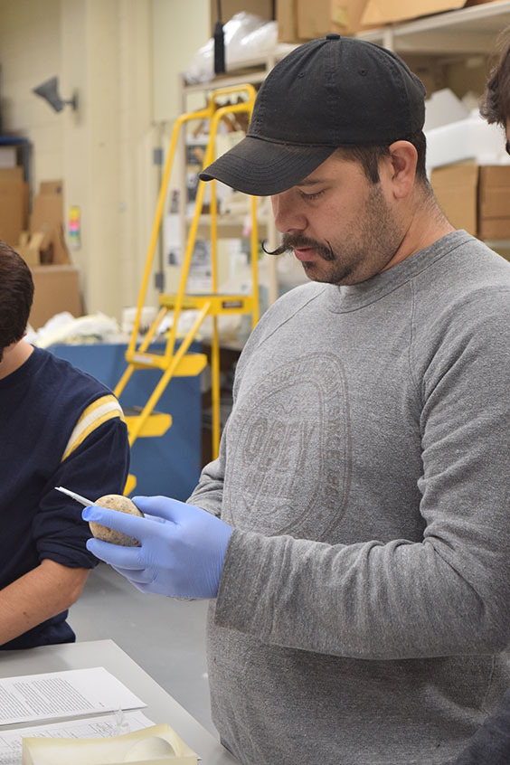 male student measuring an egg