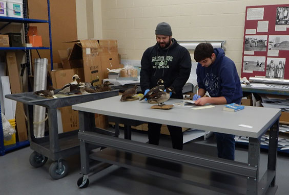 two students checking bird identification tags