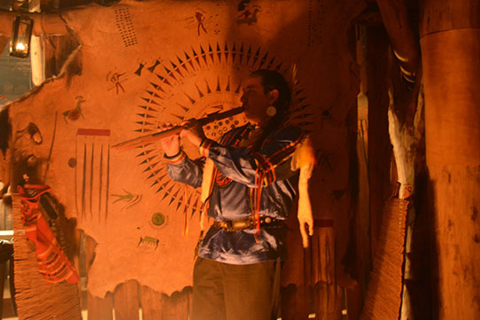 Playing flute in earthlodge