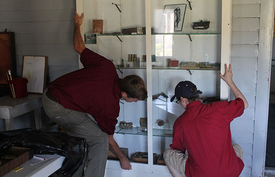 Two young gentlemen working together to open case