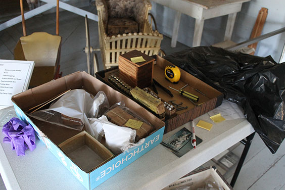 Table covered in boxes of items and tools