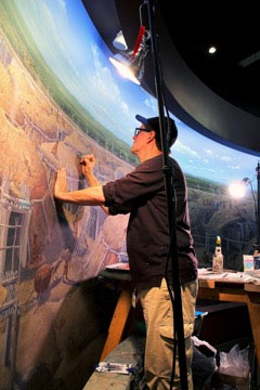 Rob Evans painting the mural