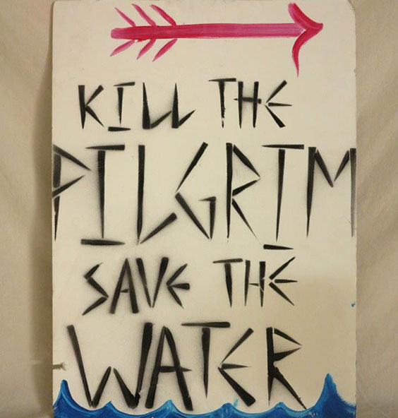 Sign with red arrow on top and water on bottom reading Kill the Pilgrim Save the Water