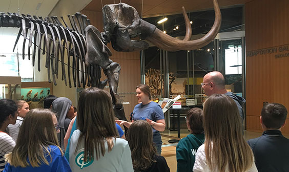 Students standing by mastodon