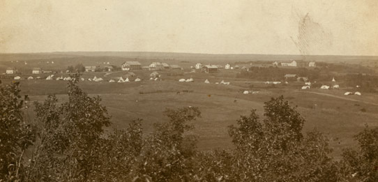 Tipis gathered outside fort